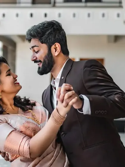 A candid moment of a couple dancing and laughing. We love capturing the fun and energy of your relationship in our pre-wedding photos.