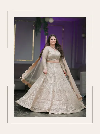 A joyful, full-length portrait of the bride twirling in her beautiful lehenga. The movement and her happy expression perfectly capture the celebratory spirit of the day.