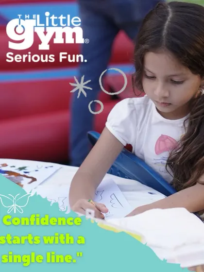 A young girl focuses on her drawing, reminding us that confidence can start with a single creative line. We make space for kids to imagine and grow.