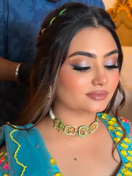 Here is your Haldi carnival look inspiration. We created this stunning look with a focus on the eyes, using a shimmery blue liner to add a pop of color and understated glam.