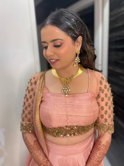 Another angle of this sparkling style. The glitter is concentrated at the roots for a trendy effect that catches the light beautifully, complementing her radiant makeup.