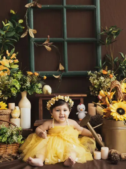A happy smile surrounded by sunflowers. We create detailed, immersive sets to make every photoshoot a unique and memorable experience.