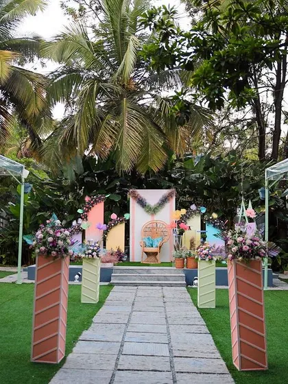 Another view of a colorful Seemantham ceremony at Farmhouse Collective, showing the full lawn setup with guest seating and stage decor.