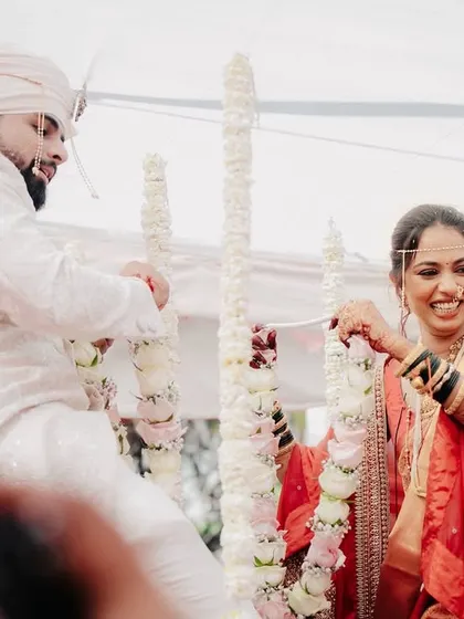 A candid moment of laughter between the bride and groom during a wedding ritual.
