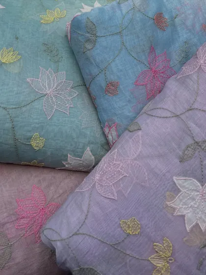 A collection of our Malai Chanderi fabrics in beautiful pastel shades, all featuring delicate floral embroidery for a soft and sophisticated feel.