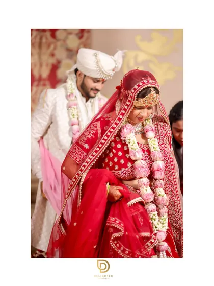 The bride and groom taking their first steps together during the pheras. This is a significant part of the wedding ceremony, symbolizing their journey forward as a married couple.