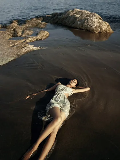 A serene moment captured on a beach using only natural light. This style of outdoor portfolio shoot is about creating a raw, authentic connection between the model and the environment, resulting in effortless and timeless images.