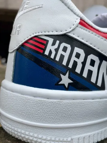 A detailed close-up of the heel, where we painted the client's name "KARAN" in the iconic Top Gun font with star and stripe details.