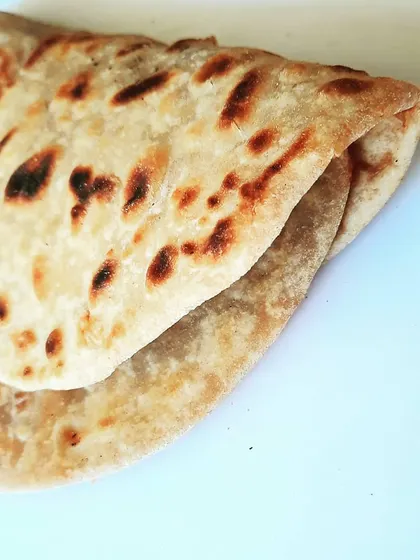 We never use factory-made bread. Every roll is wrapped in either a soft, homemade chapati or a special paratha, like this one made for our Bombay Kheema. It’s the foundation of a truly authentic roll.