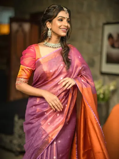 A beautiful dual-tone silk saree in purple and orange, paired with a matching blouse.