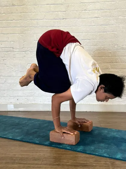 Bakasana (Crow Pose) is a foundational arm balance that builds strength and focus. Our TTC students practice this pose with blocks to understand the mechanics of weight distribution and core engagement, essential for teaching arm balances.