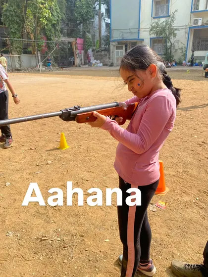 Aahana carefully aims her rifle, putting the lessons on stance and breathing into practice.