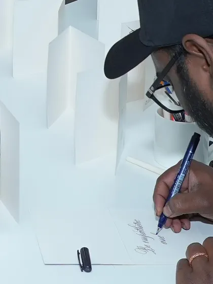 Learn the elegant art of calligraphy and add a personal, handmade touch to cards, letters, and artwork. Our instructor is demonstrating a brush lettering technique, one of several styles we explore in our classes. It's a timeless skill that brings beauty to the written word.