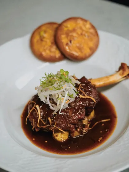 A hearty and flavorful Mutton Chop, slow-cooked and served with soft sheermal bread. It's a crowd-pleasing dish that is both rustic and refined.