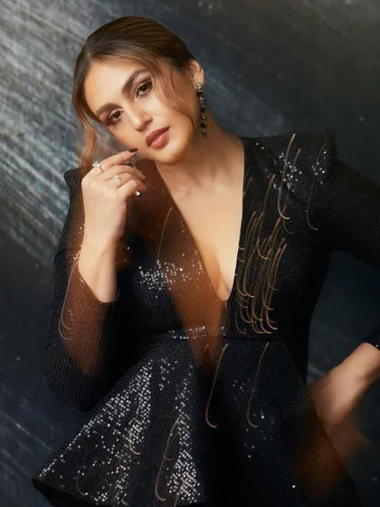 A closer look at the sequined top. The structured shoulders and deep V-neck make it a powerful and glamorous choice.