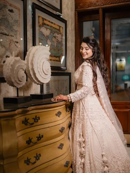 A solo portrait of the bride looking radiant before her Sangeet. The classic decor and her elegant pose create a timeless and beautiful image.