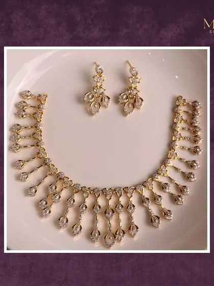When gold meets grace, magic happens. This beautiful necklace features a cascade of diamond-studded droplets, creating a look that is light, airy, and full of sparkle.