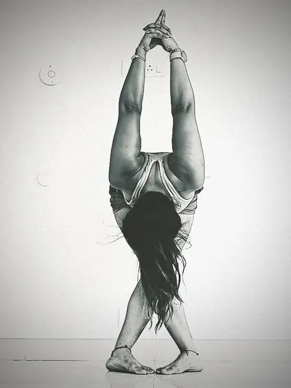 A black and white version of the 'Fishtail Fold', emphasizing the lines and symmetry of the pose. This creative forward bend is a great way to explore flexibility in a new way.