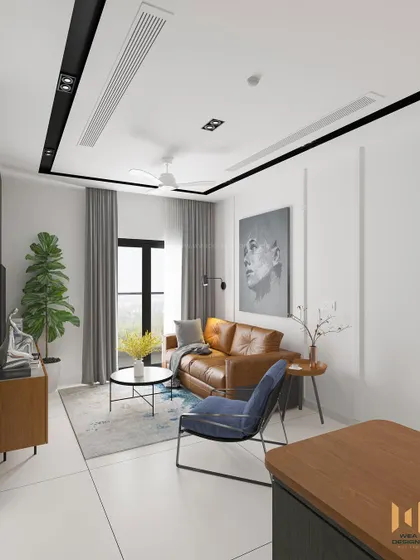 The living area of the Nano Home, with a tan leather sofa, simple white walls with beading, and a compact coffee table.