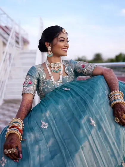 Minakshi looked like a modern Maharani for her reception. The unique blue lehenga was the star, so we created a soft yet defined makeup look to match.