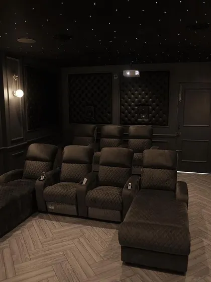 A duplicate of 213, this image captures the dark, intimate, and luxurious atmosphere of the room when it's time to watch a film.