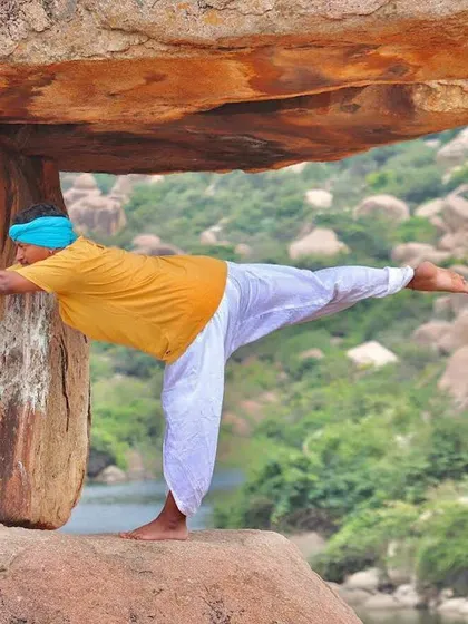 Exploring physical alignment while balancing on the rocks in Hampi. This practice is about creating straight lines and stacking bones to build a stable foundation, both in the posture and in life.