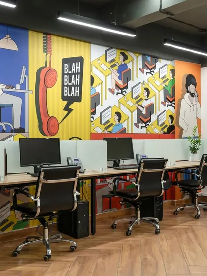 The open-plan workstation area is anything but boring. A full-wall graphic with comic-book style art adds a sense of fun and creativity to the main work zone.
