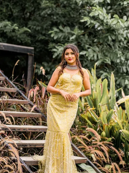 A closer look at the yellow sequined fishtail gown. The fit is designed to be flattering and comfortable, allowing you to look and feel your best.