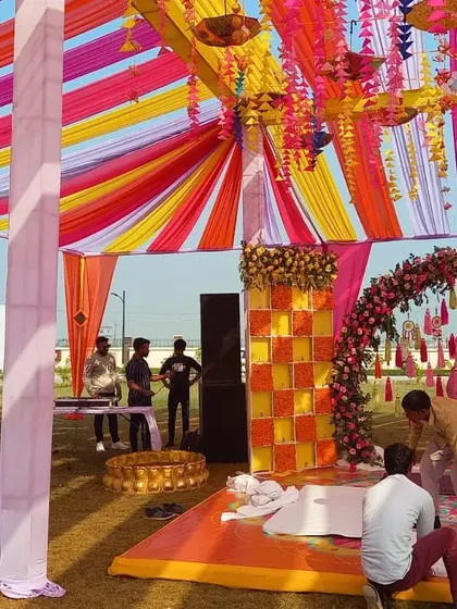 A colorful setup for a Haldi and Mehndi event. The vibrant drapes, floral arrangements, and themed decor create a festive and cheerful ambiance for your pre-wedding functions.