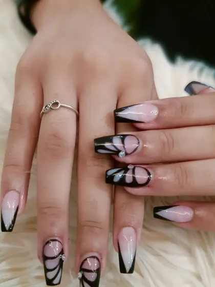 A full view of the elegant black butterfly wing manicure.