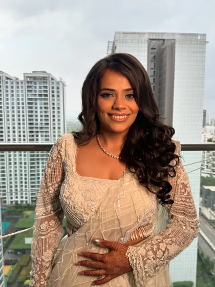 Another beautiful shot of the sister of the groom. The soft curls and dewy makeup create a look that is both modern and timelessly beautiful.