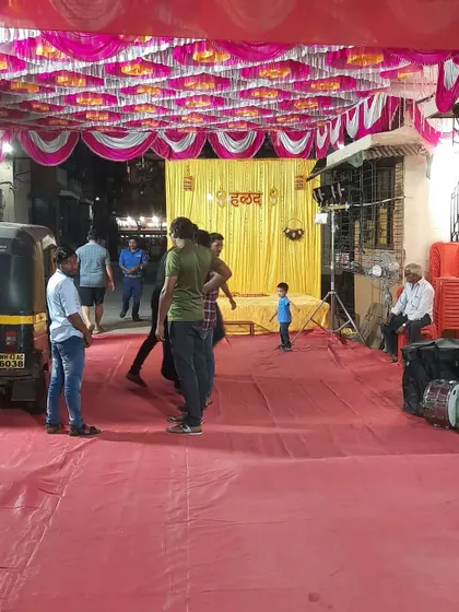 The event space before the guests arrive. This shows the clean setup of the red carpet and the Haldi stage in the background.