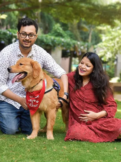 What a picture perfect family! We had so much fun during this outdoor maternity shoot, capturing this beautiful portrait of the couple with their happy golden retriever. The lush green background makes their joy pop even more.