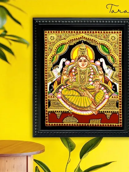 The Gaja Lakshmi Tanjore painting brings an aura of prosperity and elegance to this space. The vibrant yellow wall complements the gold in the artwork, creating a warm and inviting atmosphere.
