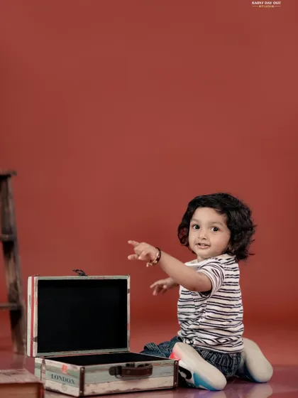 A curious toddler exploring a vintage suitcase in our studio. We love capturing their sense of wonder and discovery.
