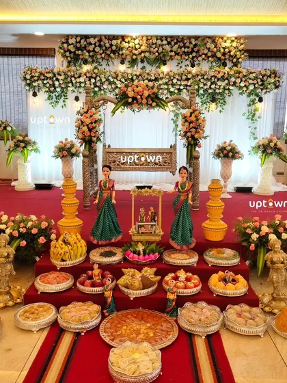 The complete stage with the cradle, offerings, and floral decor for a naming ceremony.
