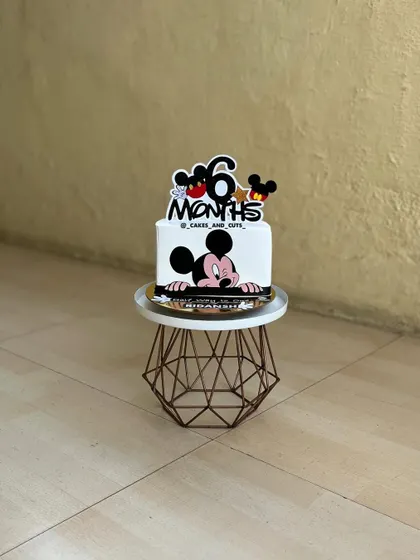 A cute Mickey Mouse cake for a half-birthday celebration. It's a great way to mark the six-month milestone.