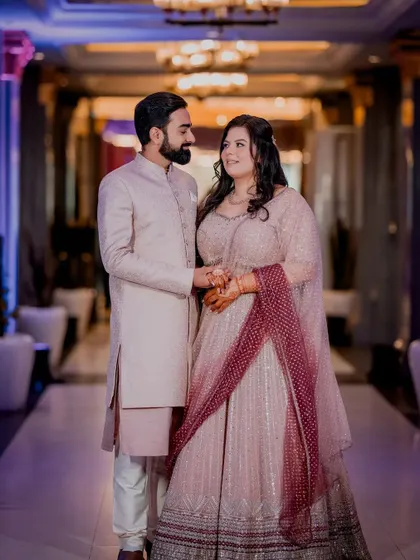 A classic portrait of the couple from their Roka ceremony, looking elegant in pastel outfits.