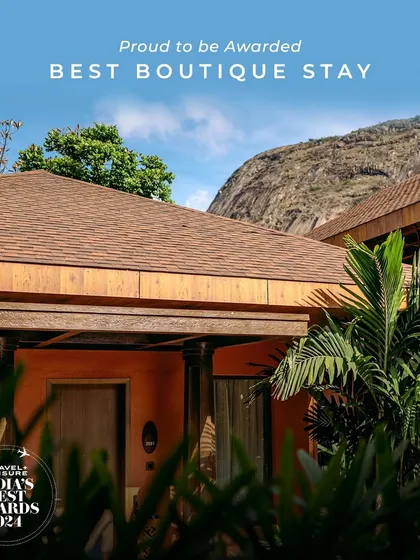 We are proud to be recognized as a Best Boutique Stay, reflected in the unique design and serene setting of our accommodations, seen here against the backdrop of Nandi Hills.