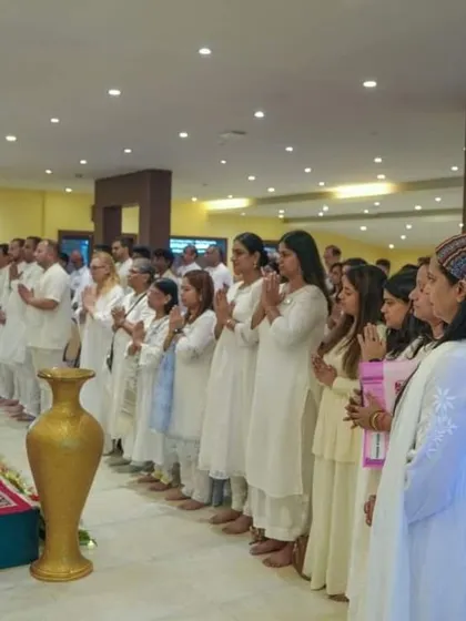 A moment of quiet reverence as participants stand in prayer during a session. The atmosphere in our Kashmir retreats is one of deep peace and spiritual focus.