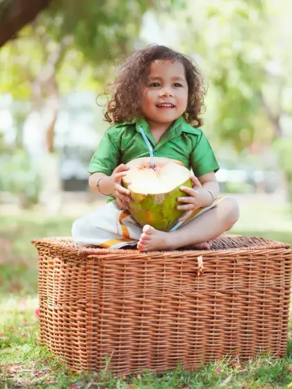 A happy smile from this little one during his outdoor photoshoot. The lush green background makes the colors of his outfit pop.