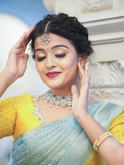 A simple yet elegant yellow blouse with delicate pearl and thread work along the neckline. It’s a beautiful option for daytime events or pre-wedding ceremonies.