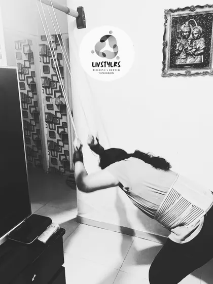 This client is using a resistance band for a lat pulldown variation. This is an excellent way to build back and shoulder strength at home without heavy equipment, demonstrating how I adapt workouts for any environment.