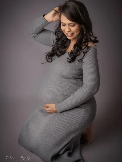 A beautiful, gentle pose on the floor. This shot highlights the mom-to-be's gorgeous hair and serene expression, creating a soft and intimate portrait.