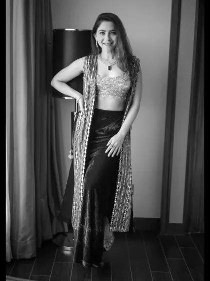 A full-length black and white portrait. The monochrome treatment gives this modern outfit a classic and sophisticated feel.