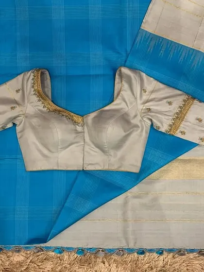 The full set of the grey and blue saree and blouse, a sophisticated and unique color combination.