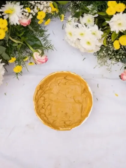 A close-up of the Haldi paste, surrounded by fresh flowers, ready for the auspicious and fun-filled ceremony to begin.