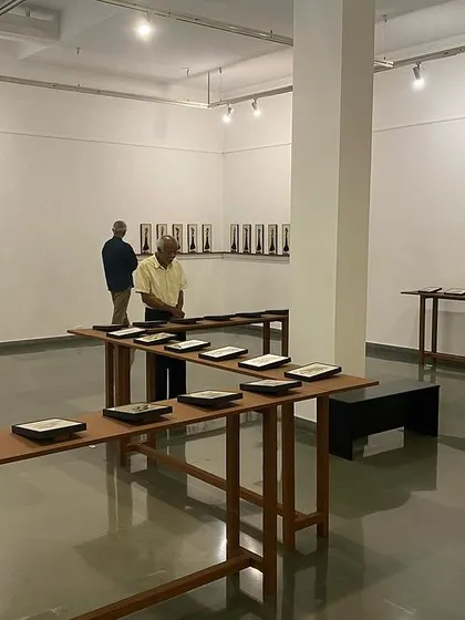 The gallery space during 'Quieter than Silence', with visitors contemplating the works from a distance.
