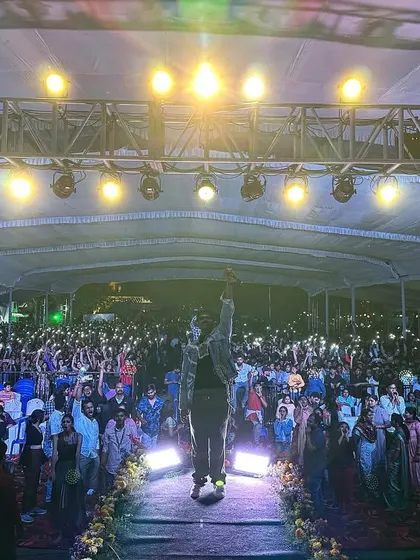 Standing on the stage walkway, I raise a hand to connect with the massive audience at the Cambridge Institute of Technology fest.