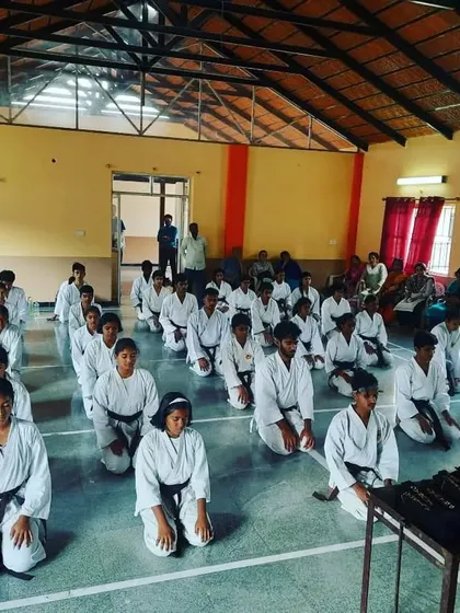Students kneeling in seiza, waiting for the black belt grading exam to begin. This moment is filled with nervous anticipation and reflects the formal discipline of traditional karate.
